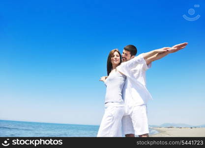 happy young couple have fun and romantic moments on beach at summer season and representing happynes and travel concept