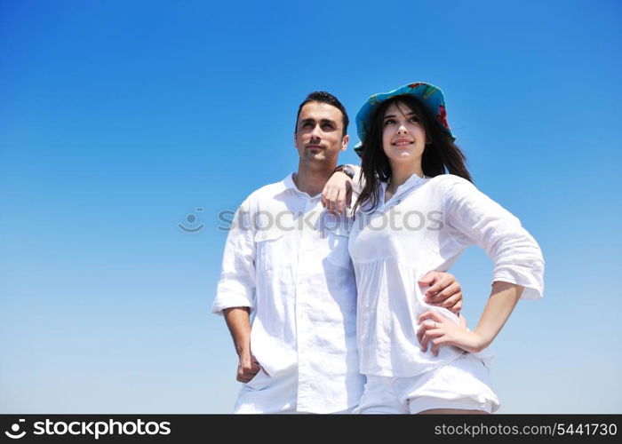 happy young couple have fun and romantic moments on beach at summer season and representing happynes and travel concept