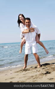 happy young couple have fun and romantic moments on beach at summer season and representing happynes and travel concept