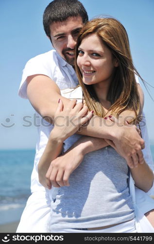 happy young couple have fun and romantic moments on beach at summer season and representing happynes and travel concept