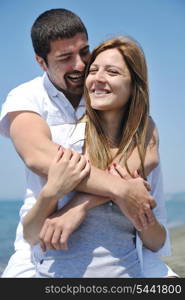 happy young couple have fun and romantic moments on beach at summer season and representing happynes and travel concept