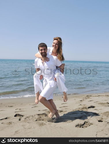 happy young couple have fun and romantic moments on beach at summer season and representing happynes and travel concept