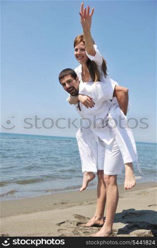 happy young couple have fun and romantic moments on beach at summer season and representing happynes and travel concept