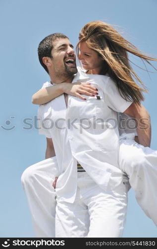 happy young couple have fun and romantic moments on beach at summer season and representing happynes and travel concept