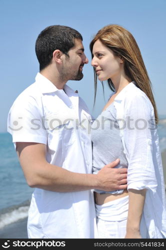 happy young couple have fun and romantic moments on beach at summer season and representing happynes and travel concept