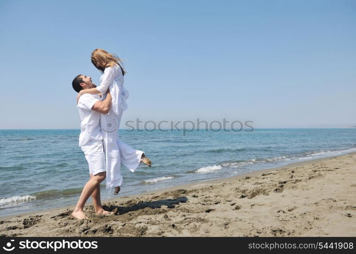 happy young couple have fun and romantic moments on beach at summer season and representing happynes and travel concept