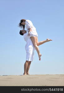 happy young couple have fun and romantic moments on beach at summer season and representing happynes and travel concept