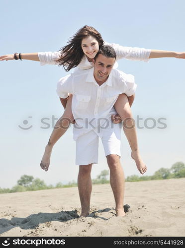 happy young couple have fun and romantic moments on beach at summer season and representing happynes and travel concept