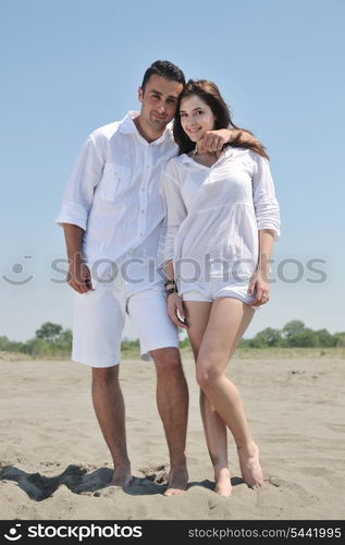 happy young couple have fun and romantic moments on beach at summer season and representing happynes and travel concept