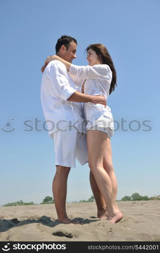 happy young couple have fun and romantic moments on beach at summer season and representing happynes and travel concept