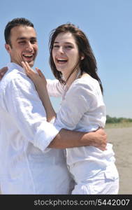 happy young couple have fun and romantic moments on beach at summer season and representing happynes and travel concept