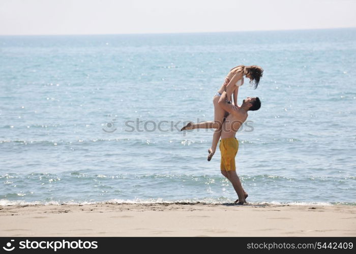 happy young couple have fun and romantic moments on beach at summer season and representing happynes and travel concept