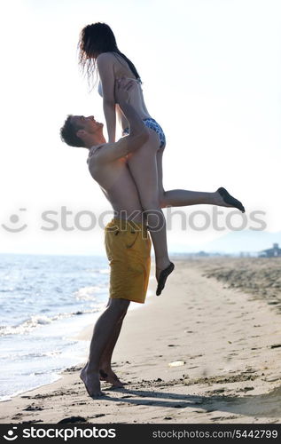 happy young couple have fun and romantic moments on beach at summer season and representing happynes and travel concept