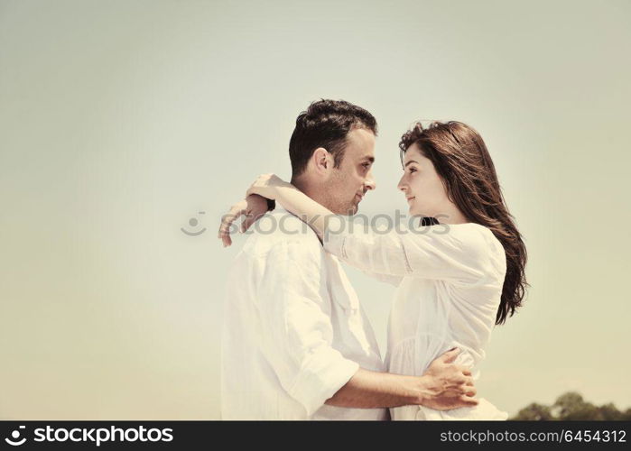 happy young couple have fun and romantic moments on beach at summer season and representing happynes and travel concept