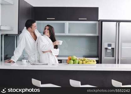 happy young couple have fun in modern kitchen indoor while preparing fresh fruits and vegetables food salad