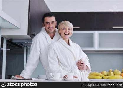 happy young couple have fun in modern kitchen indoor while preparing fresh fruits and vegetables food salad