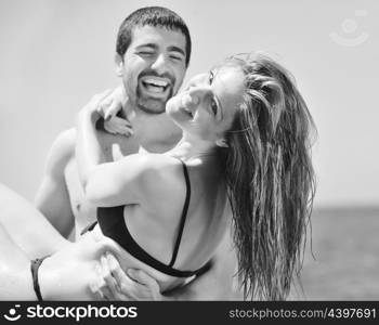 happy young couple have romantic time on beach at sunset