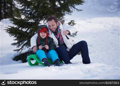 happy young couple having fun and walking in snow shoes outdoor in nature at beautiful winter day. Health sport and relaxation