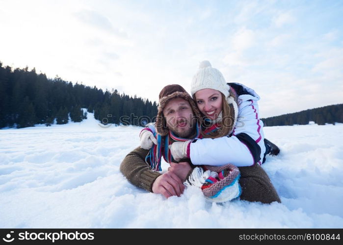 happy young couple having fun and walking in snow shoes outdoor in nature at beautiful winter day. Health sport and relaxation