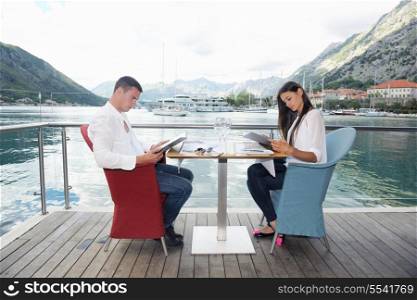 happy young couple having lanch at beautiful restaurant on by the sea on beach