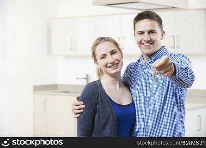 Happy Young Couple Holding Keys To New Home