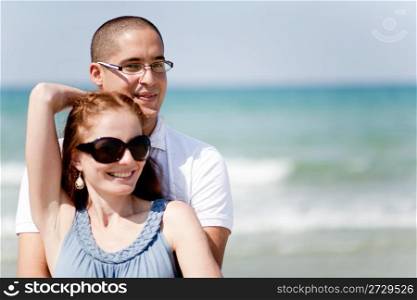 happy Young couple holding passionately at the beach half length