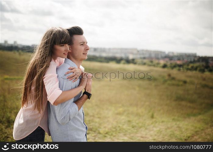 Happy young couple hugging and laughing outdoors. Love and tenderness.Lifestyle concept.. Happy young couple hugging and laughing outdoors. Love and tenderness. Lifestyle concept