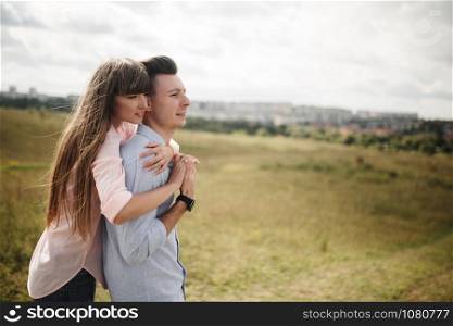 Happy young couple hugging and laughing outdoors. Love and tenderness.Lifestyle concept.. Happy young couple hugging and laughing outdoors. Love and tenderness. Lifestyle concept