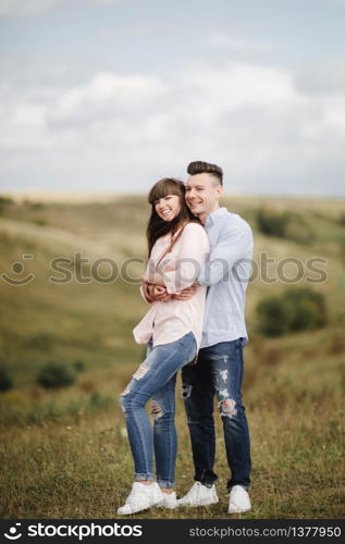 Happy young couple hugging and laughing outdoors. Love and tenderness.Lifestyle concept.. Happy young couple hugging and laughing outdoors. Love and tenderness. Lifestyle concept