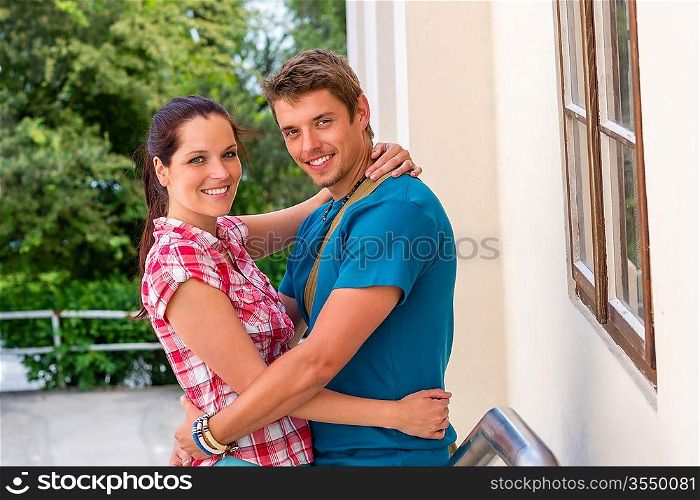Happy young couple hugging in love smiling outdoors together