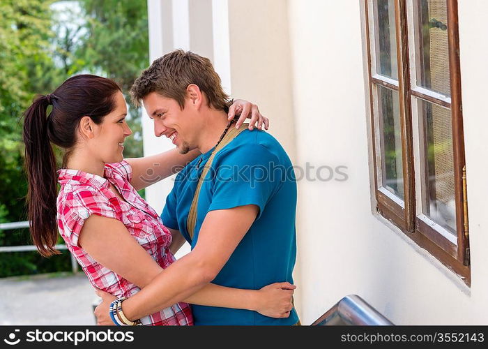 Happy young couple hugging in love smiling outdoors together