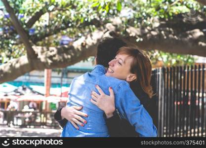 Happy young couple hugging in the park. Relationships concept