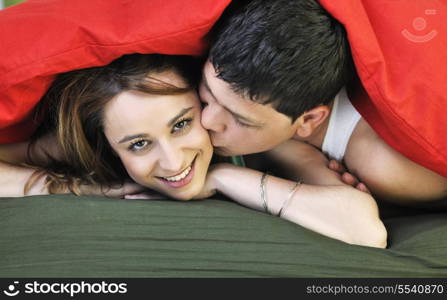 happy young couple in bed at morning