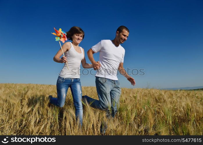 happy young couple in love have romance and fun at wheat field in summer