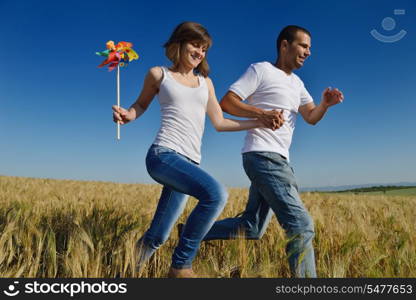 happy young couple in love have romance and fun at wheat field in summer