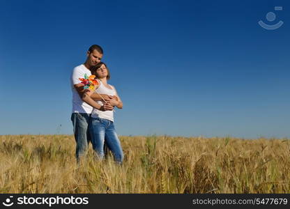 happy young couple in love have romance and fun at wheat field in summer