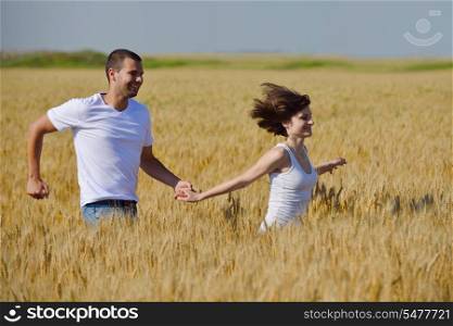 happy young couple in love have romance and fun at wheat field in summer