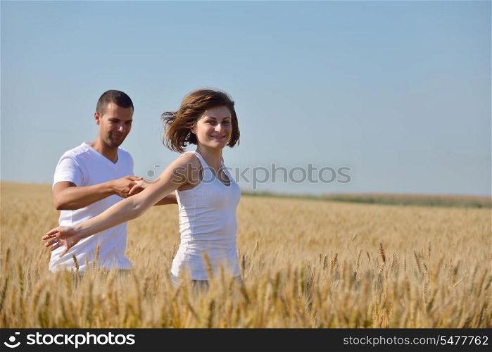 happy young couple in love have romance and fun at wheat field in summer