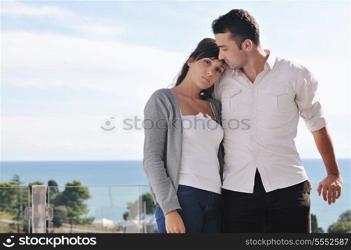 happy young couple in love have romance relax on balcony outdoor with ocean and blue sky in background