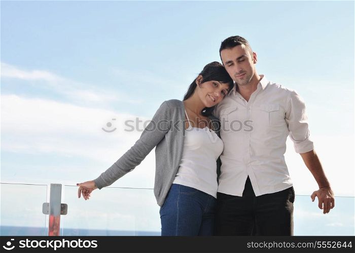 happy young couple in love have romance relax on balcony outdoor with ocean and blue sky in background