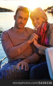 happy young couple in love have romantic time at summer sunset at ship boat while representing urban and countryside fashin lifestyle