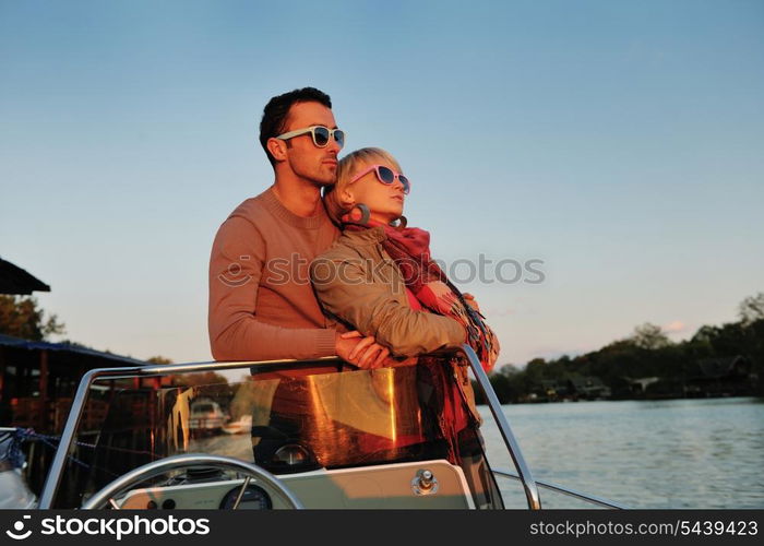 happy young couple in love have romantic time at summer sunset at ship boat while representing urban and countryside fashin lifestyle