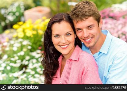 Happy young couple in love hugging in nature garden