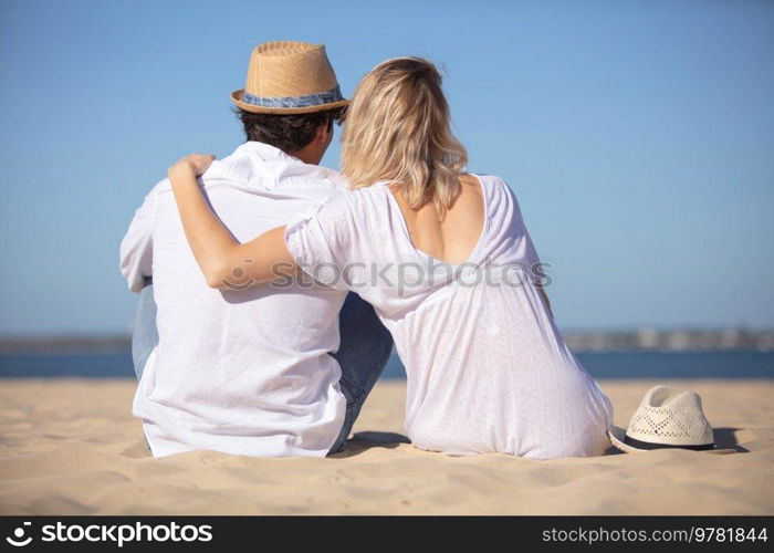 happy young couple in love relaxing on beach