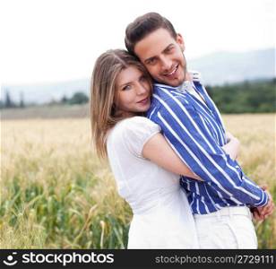 Happy young couple in the meadow