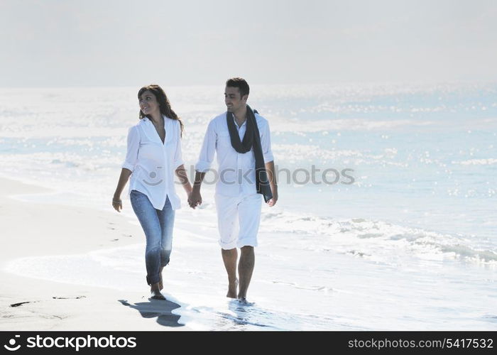 happy young couple in white clothing have romantic recreation and fun at beautiful beach on vacations