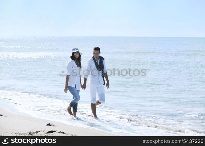 happy young couple in white clothing have romantic recreation and fun at beautiful beach on vacations