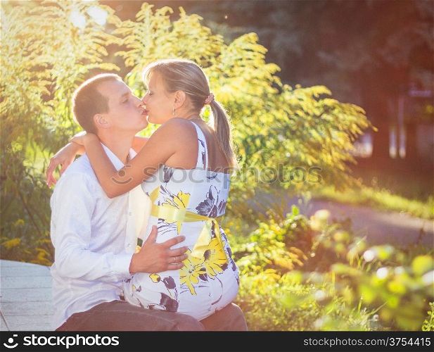 Happy young couple kissing outdoor in the park