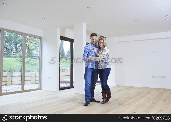 Happy Young Couple Looking At Details Of New Home