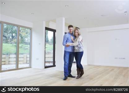 Happy Young Couple Looking At Details Of New Home